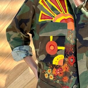Vintage army jacket artistically intervened with paint and modern  embroidery.